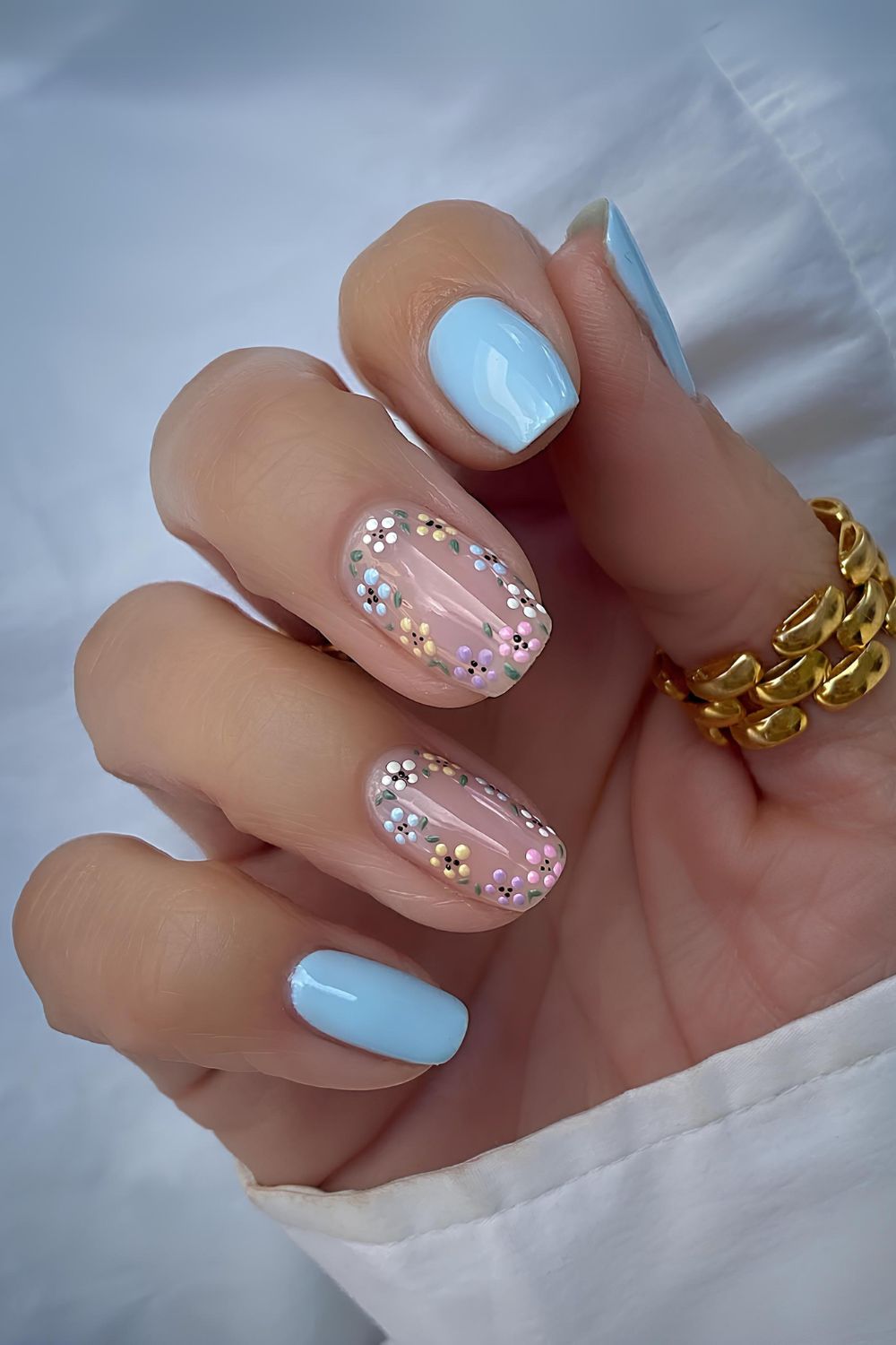 Baby blue mani with colorful flowers