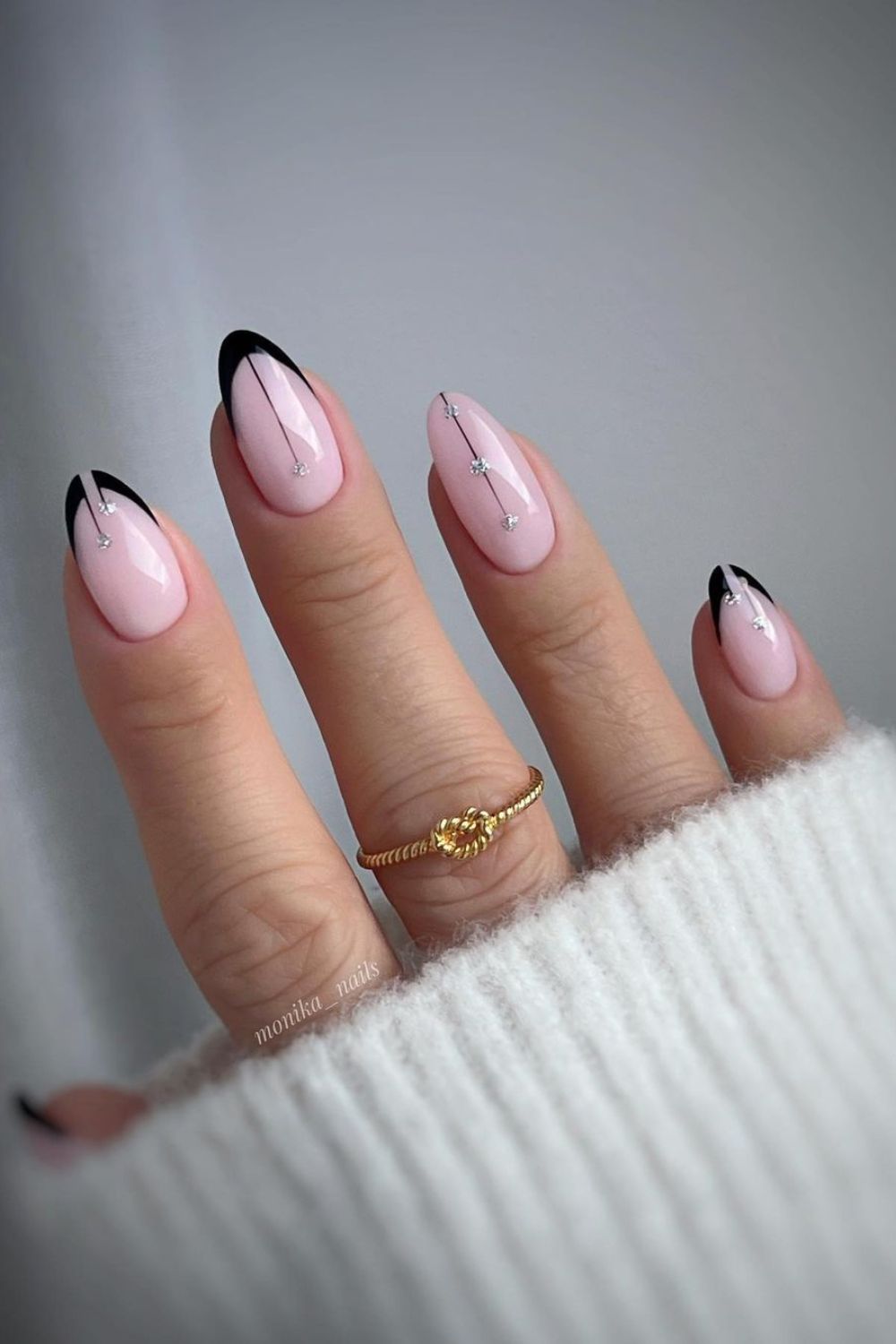 Black French tip nails with ringstones and lines