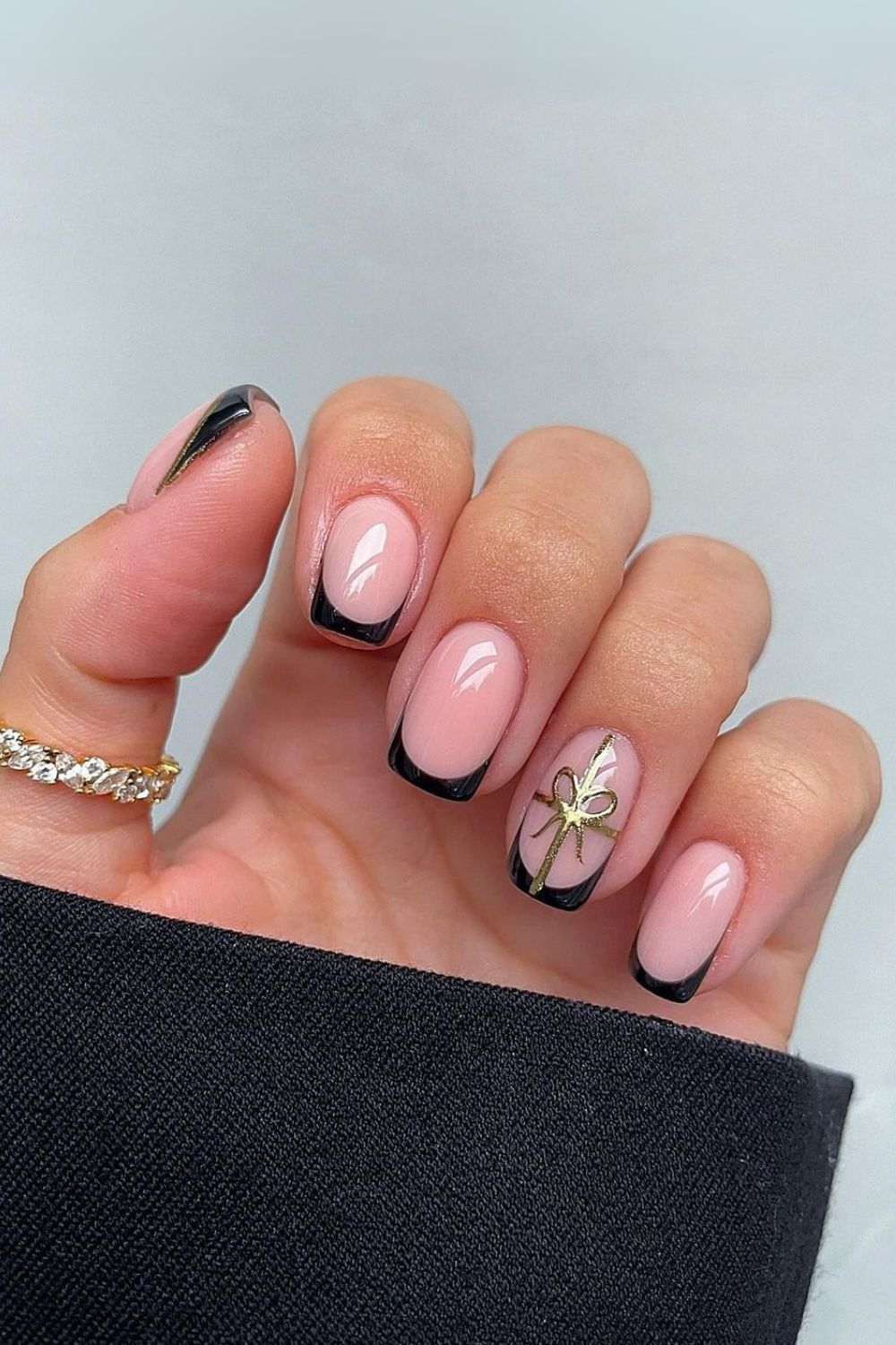 Black French tips with gold gift bow art