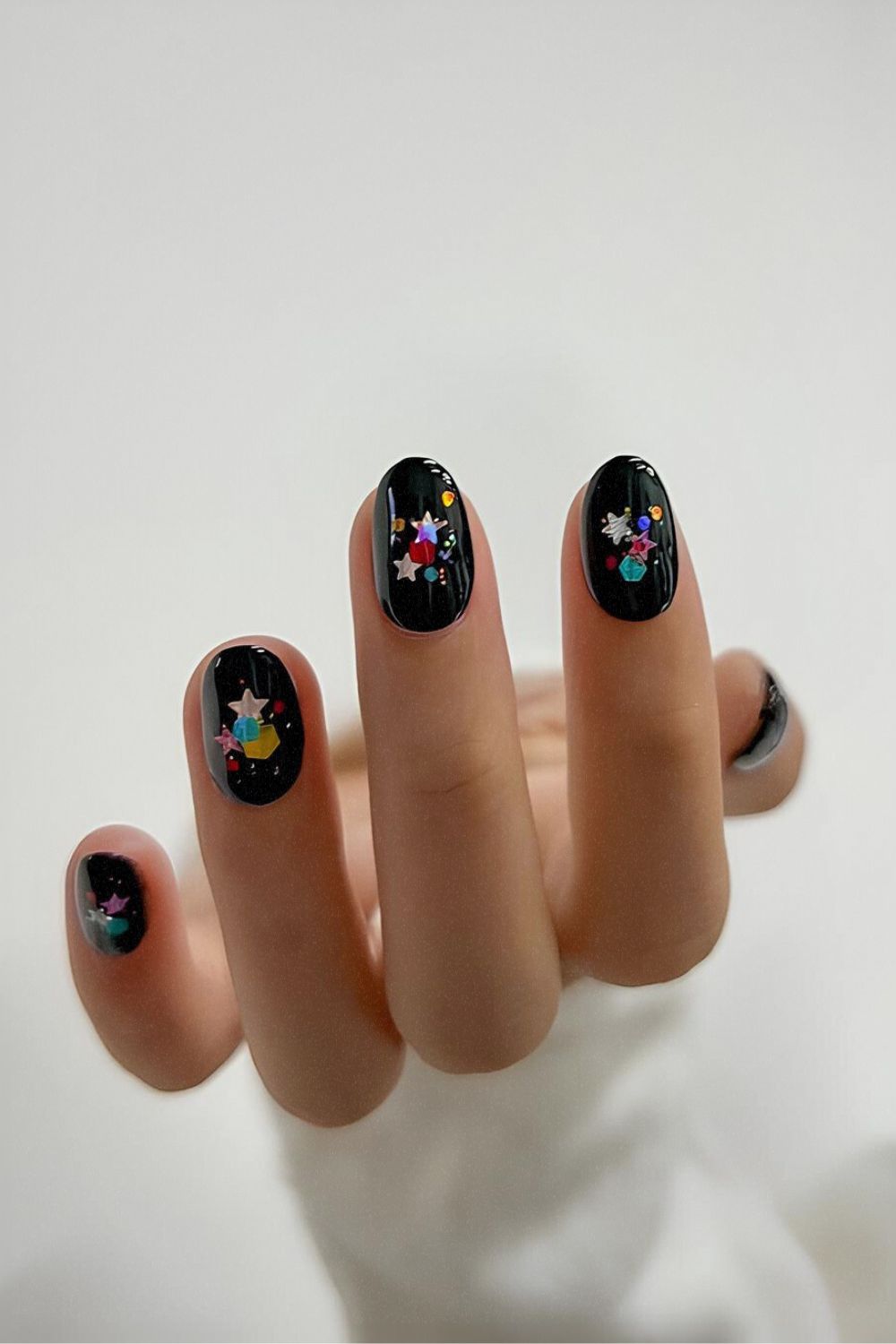 Black nails with chunky glitter accents