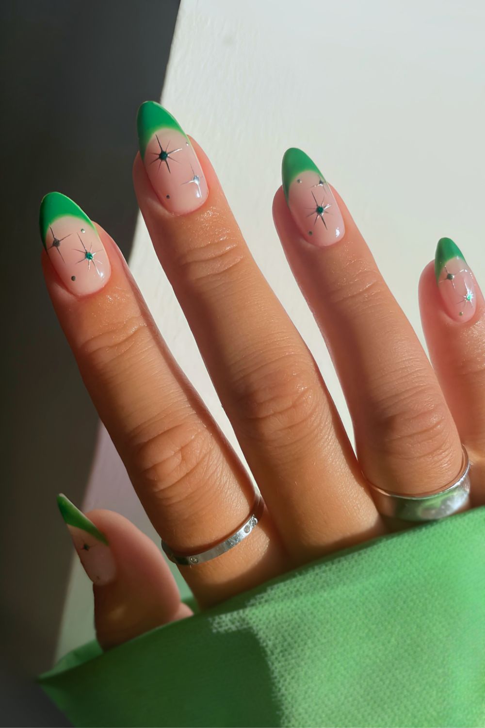 Bright green French nails with celestial accents