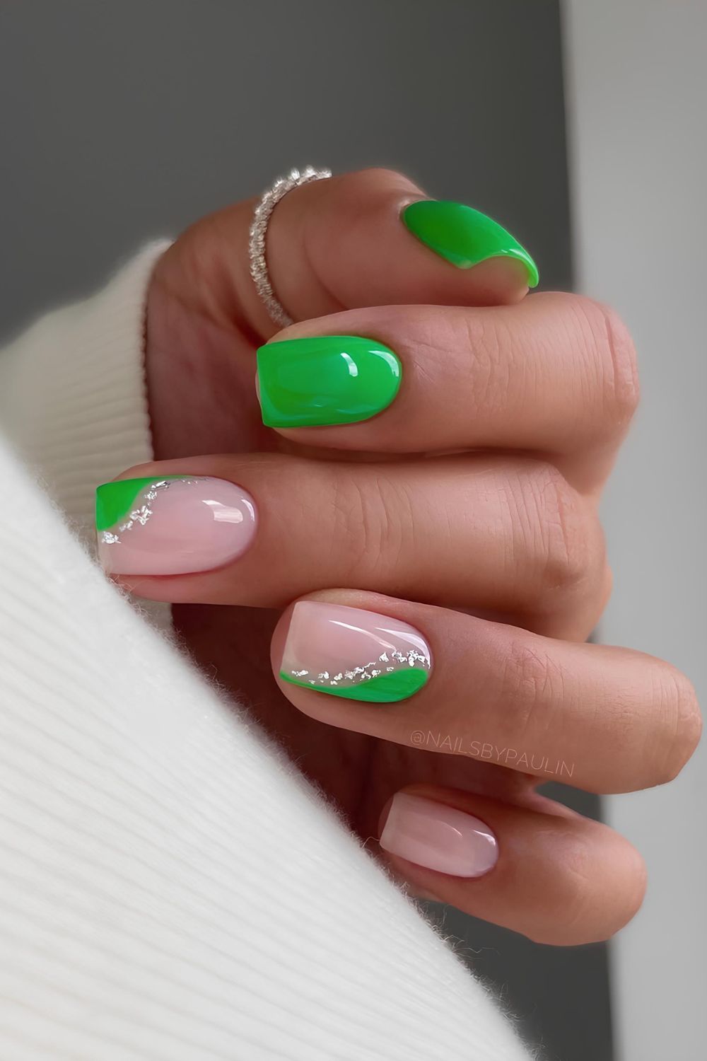 Bright green and pink nails with silver glitter accents