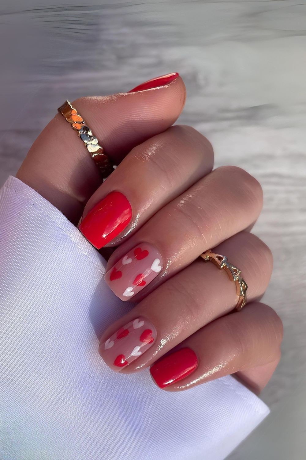 Bright red mani with tiny heart accents