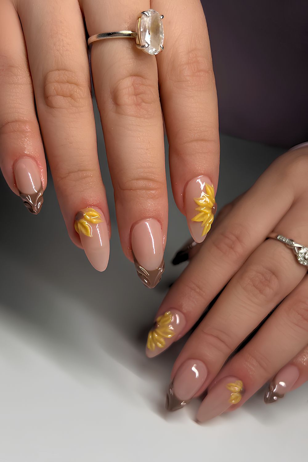 Brown French nails with 3D sunflower accents