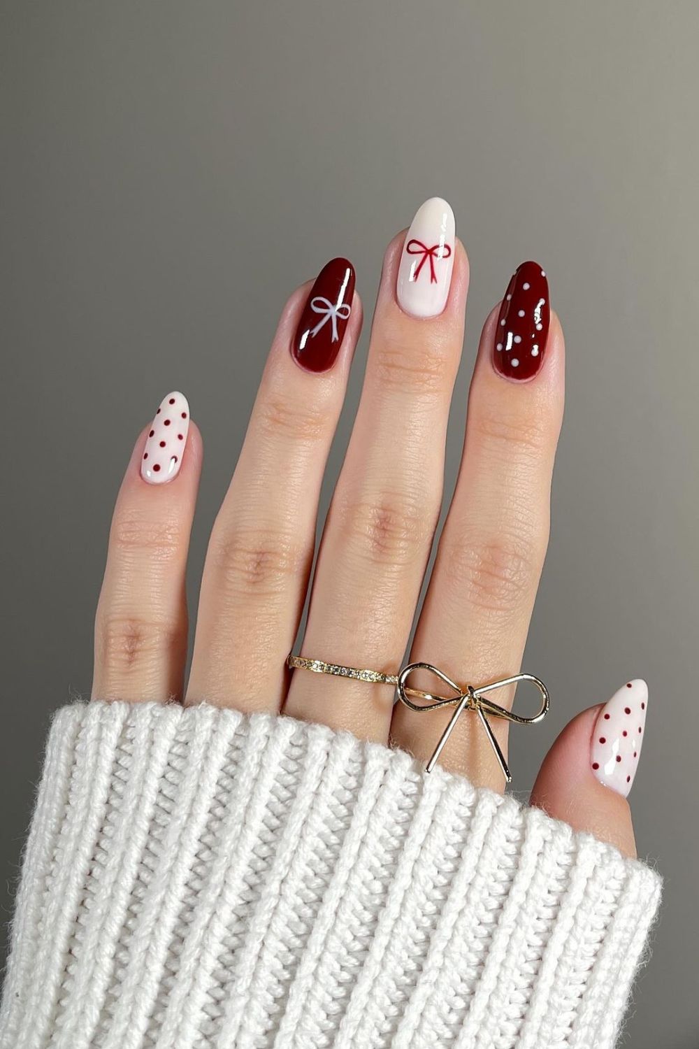 Burgundy and white nails with bows and polka dots