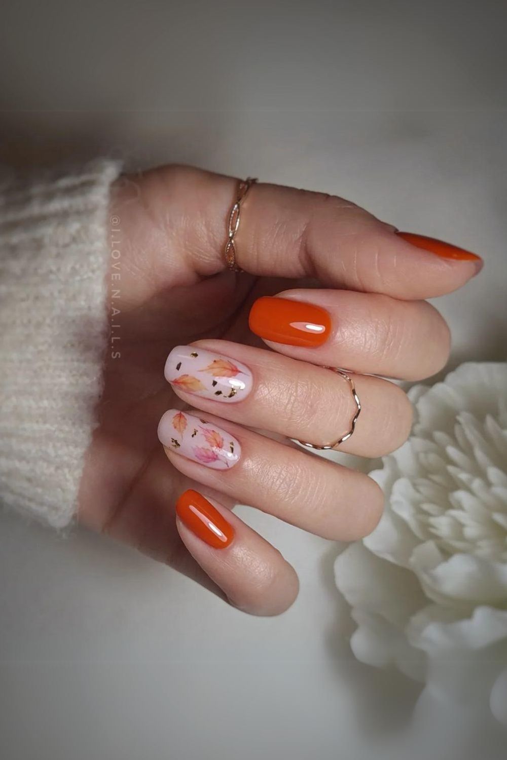 Burnt orange nails with leaf accents