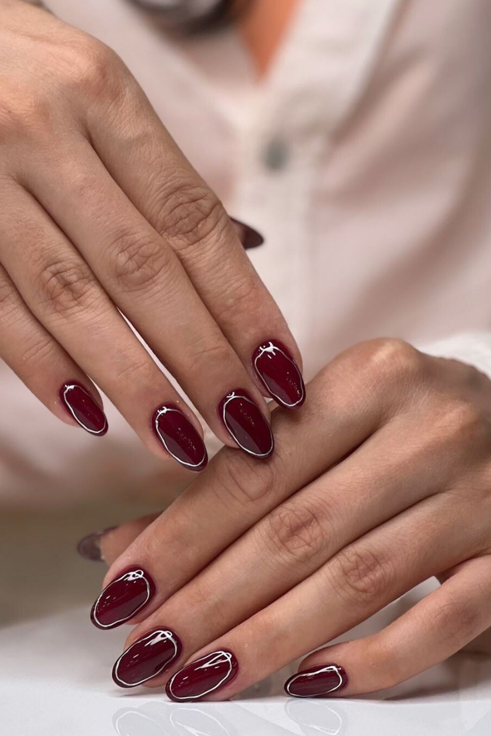 Currant red nails with silver chrome ring accents