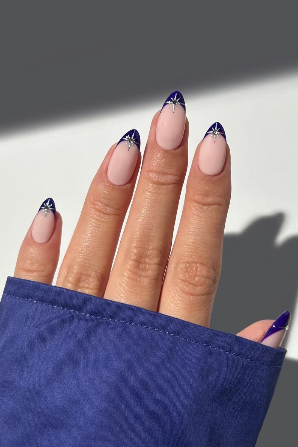 Dark blue French tip nails with silver stars