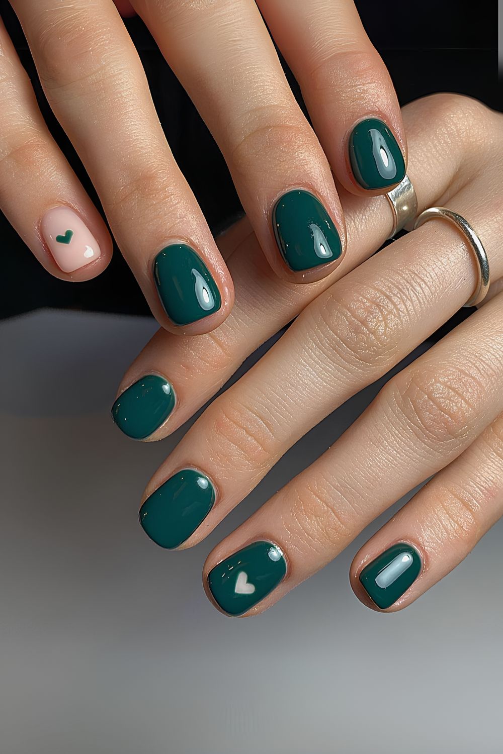 Dark green mani with tiny heart accents