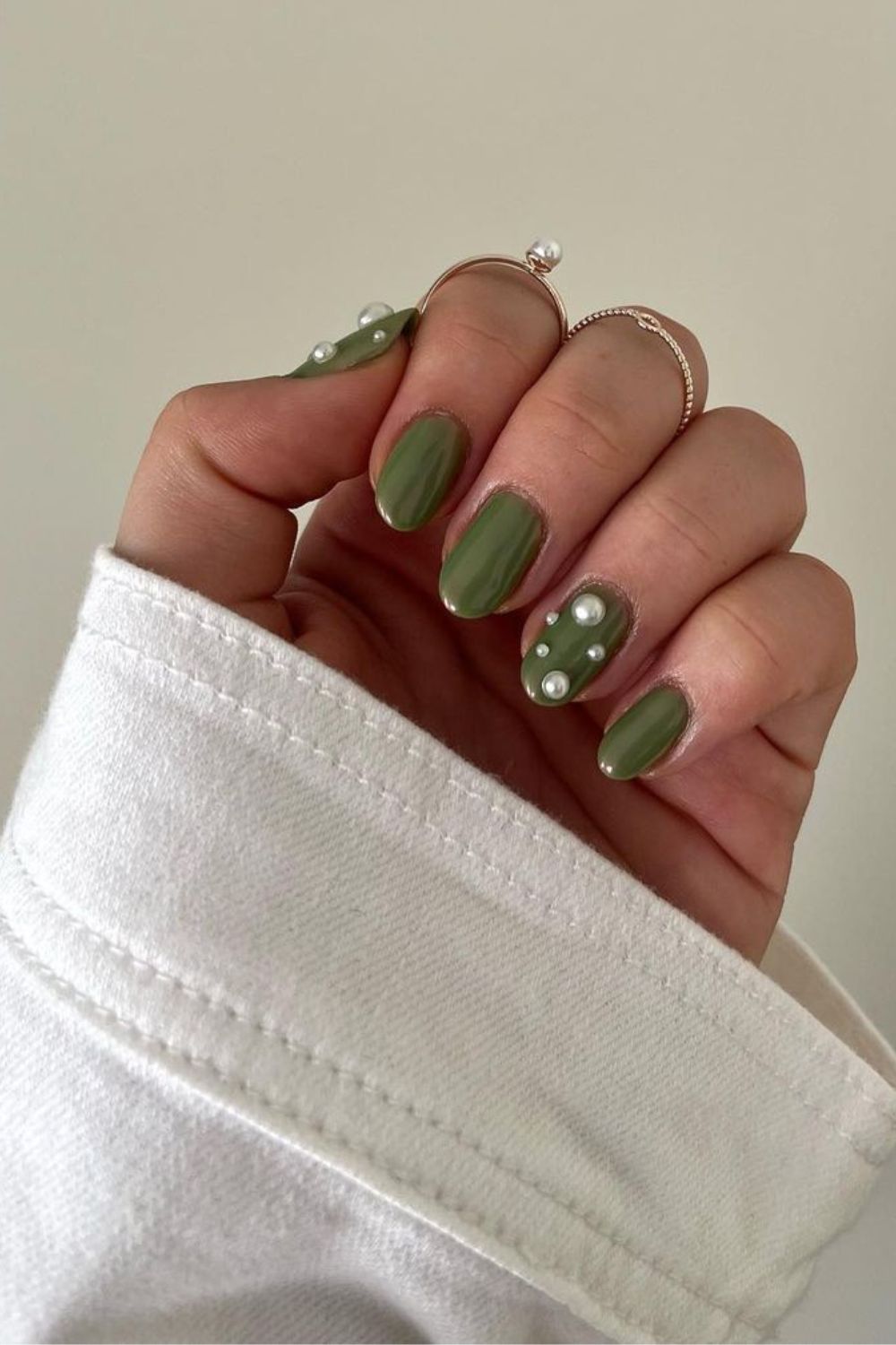 Dark olive green nails with pearl accents