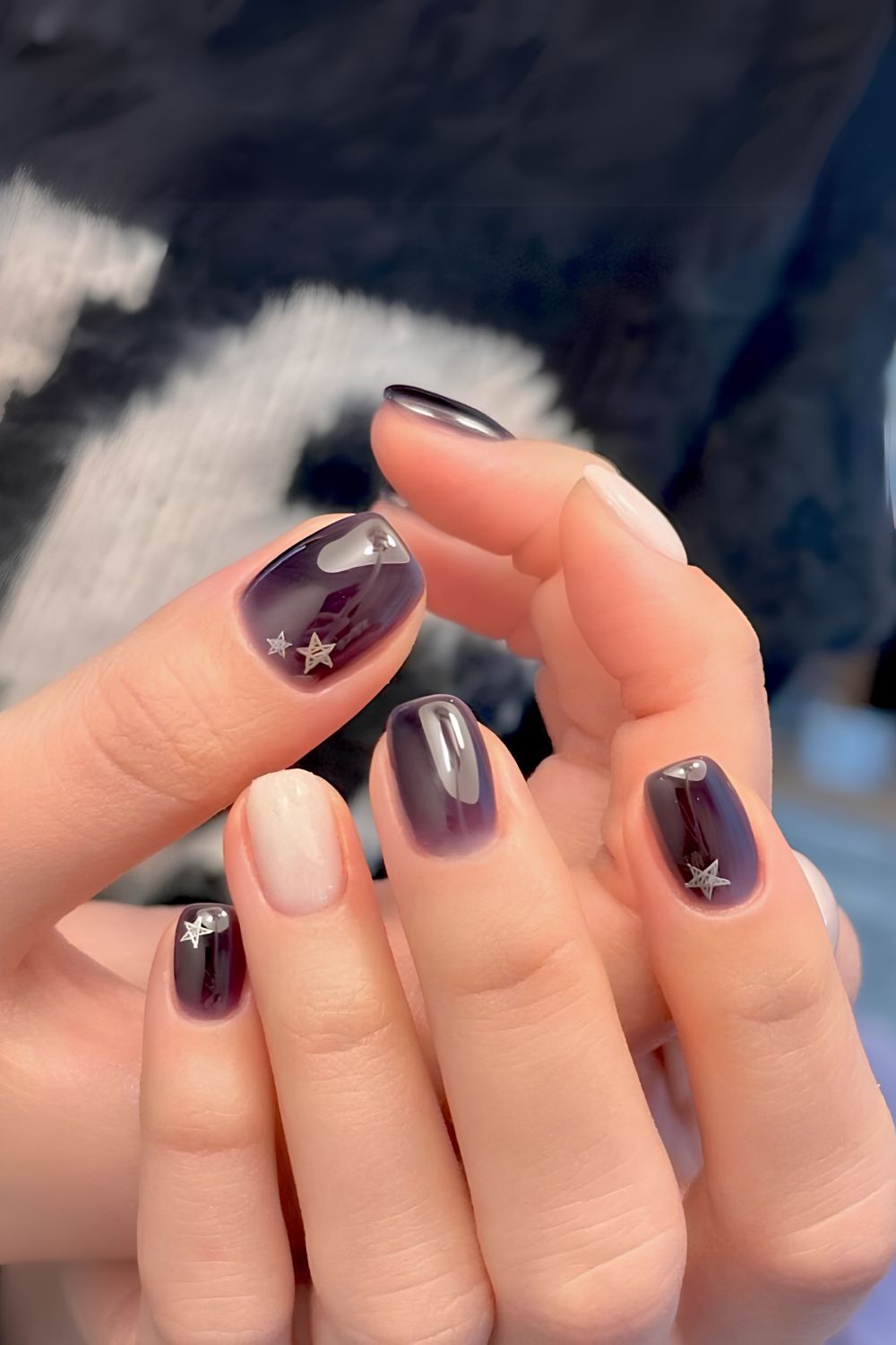 Dark purple jelly nails with silver stars