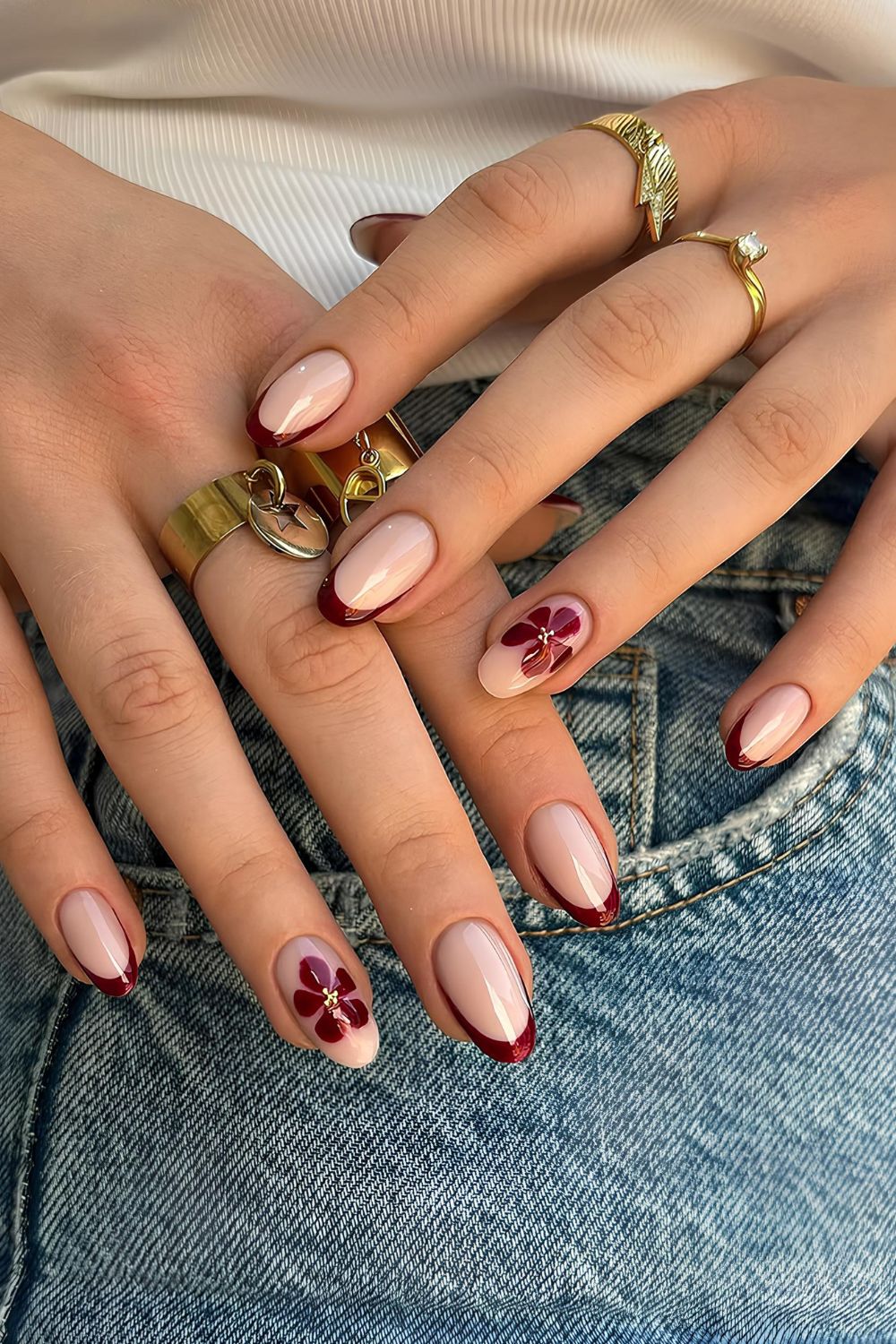 Dark red French nails with blooming flower accents