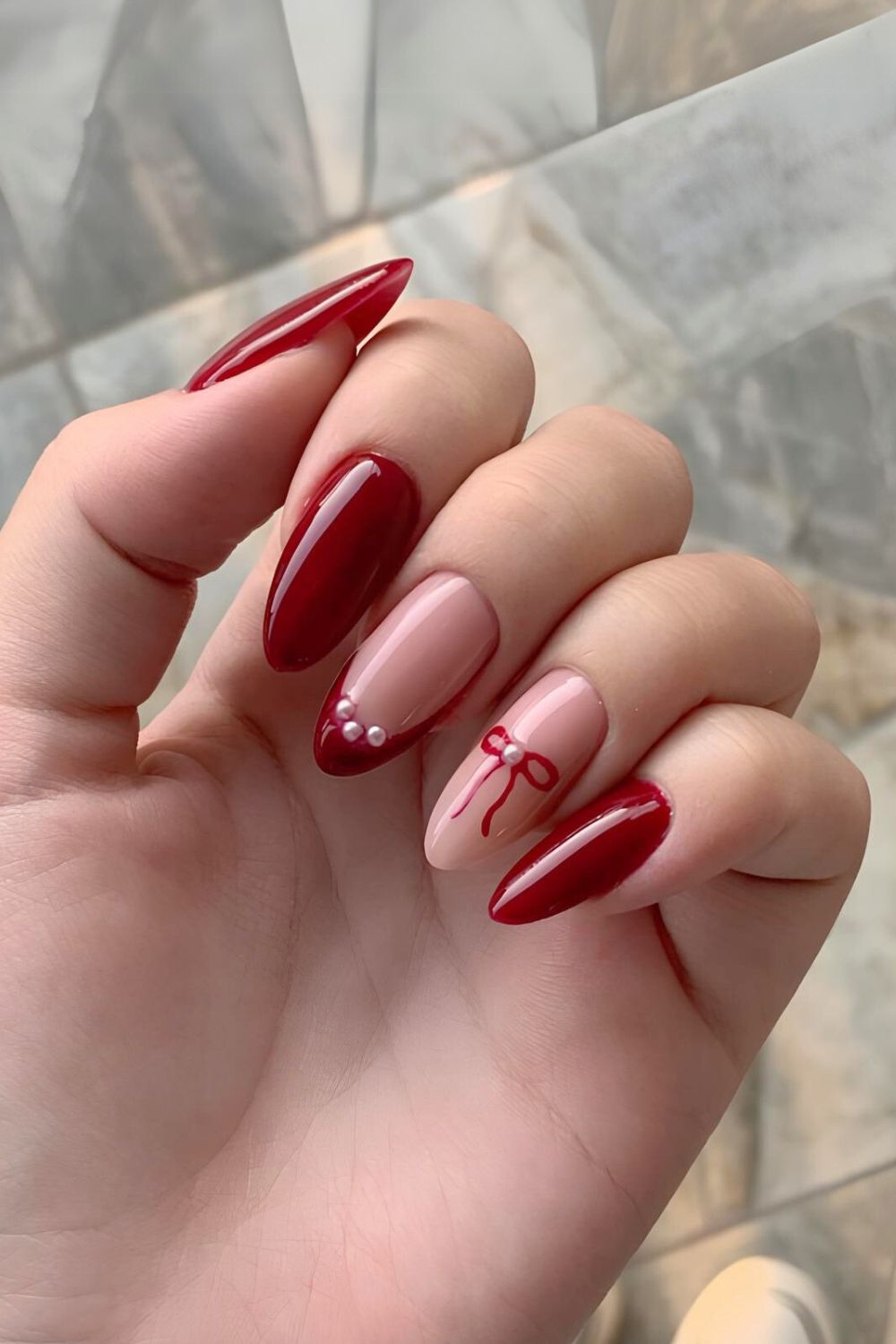 Dark red nails with bows and pearls