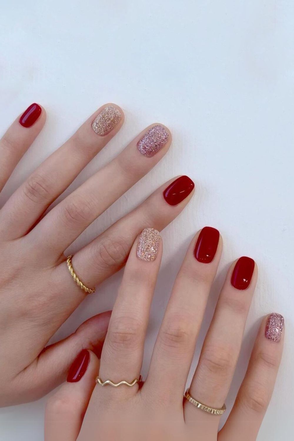 Deep red manicure with glitter accent