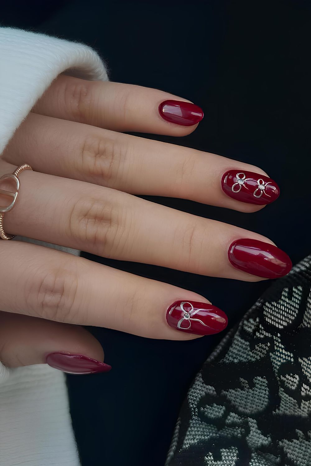 Garnet red nails with bow accents