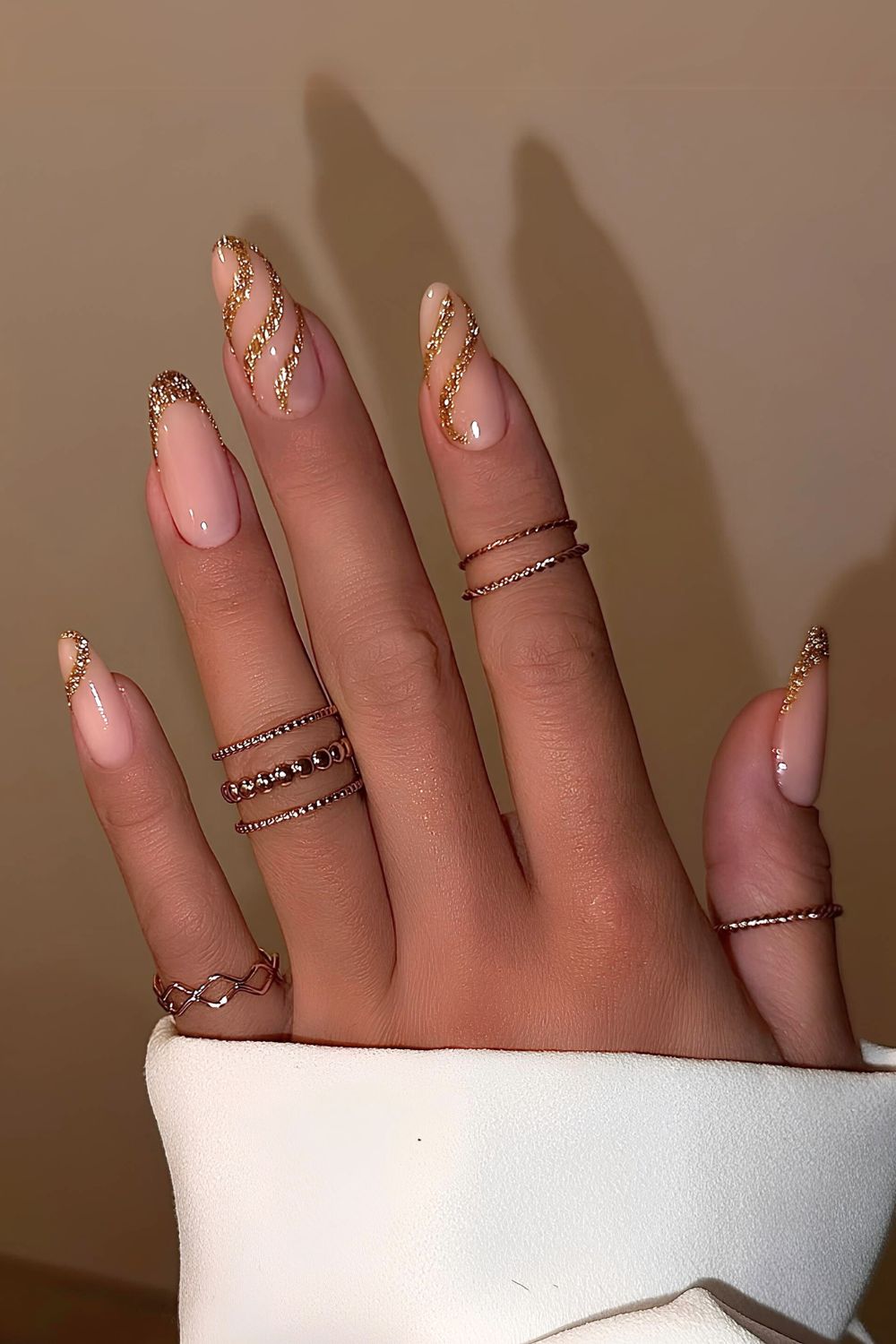 Gold glitter French nails with swirls