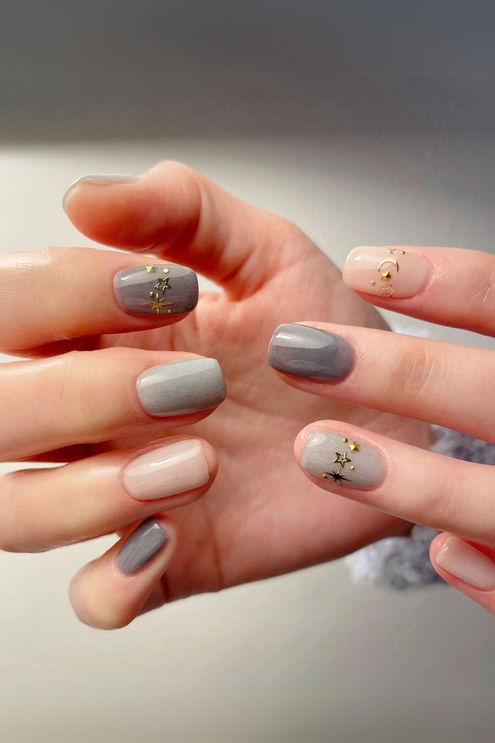 Gray nails with gold celestial charms