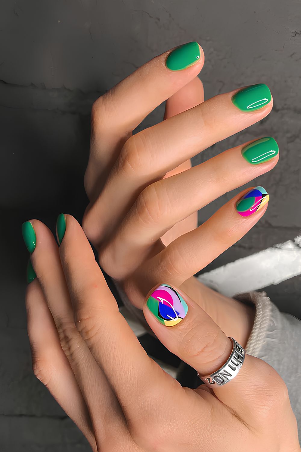 Green manicure with colorful accent nails