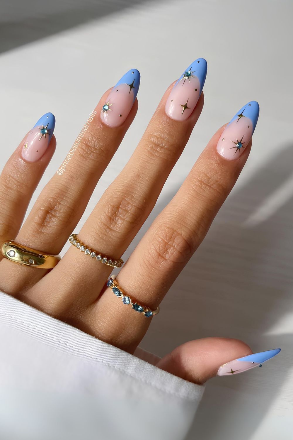 Light blue French mani with celestial charms