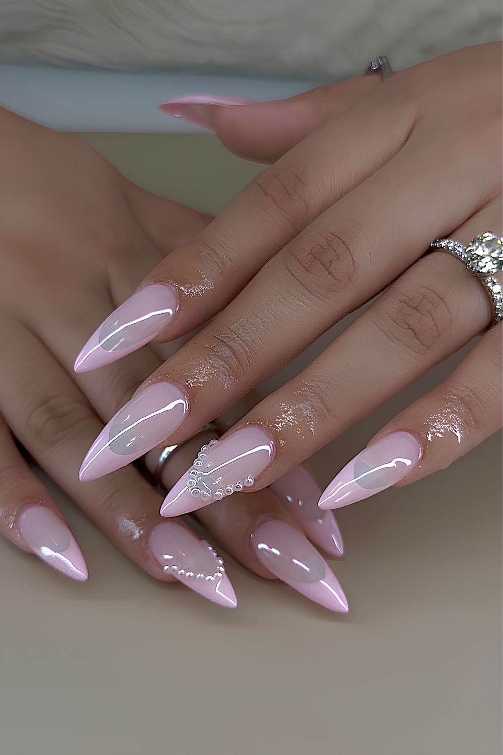 Light pink French nails with pearl accents