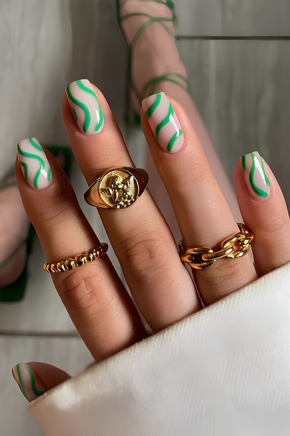 Milky nails with abstract green swirls