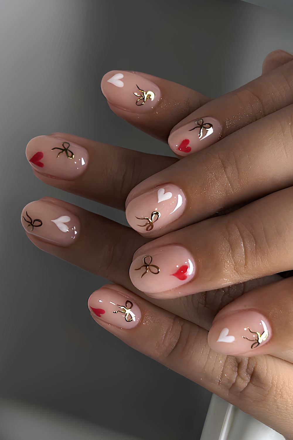 Milky nails with hearts and chrome bows