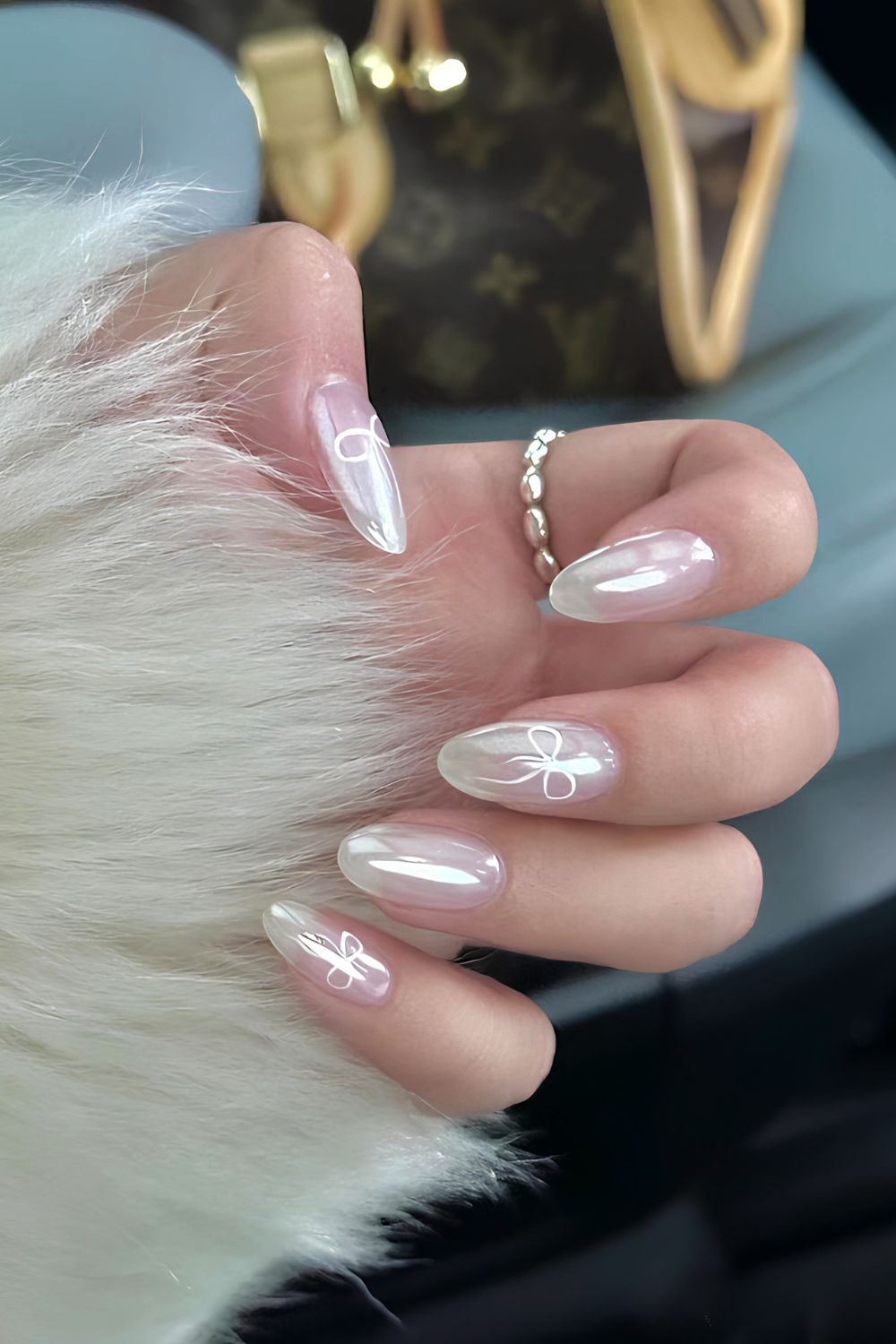 Milky white chrome nails with coquette bows