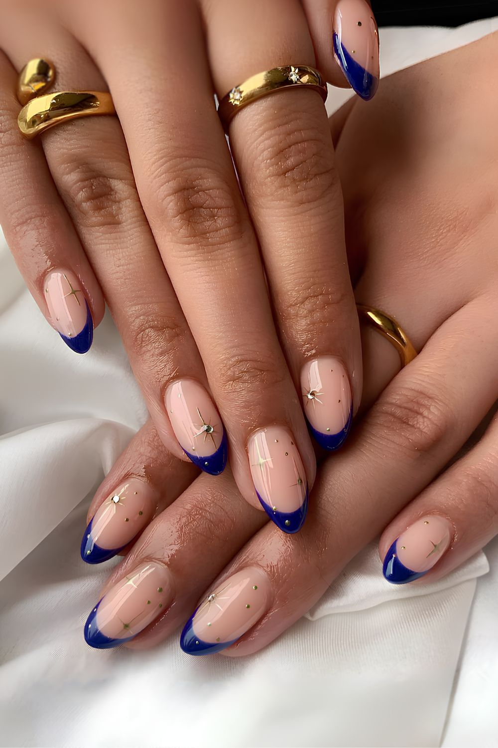 Navy blue French mani with celestial charms