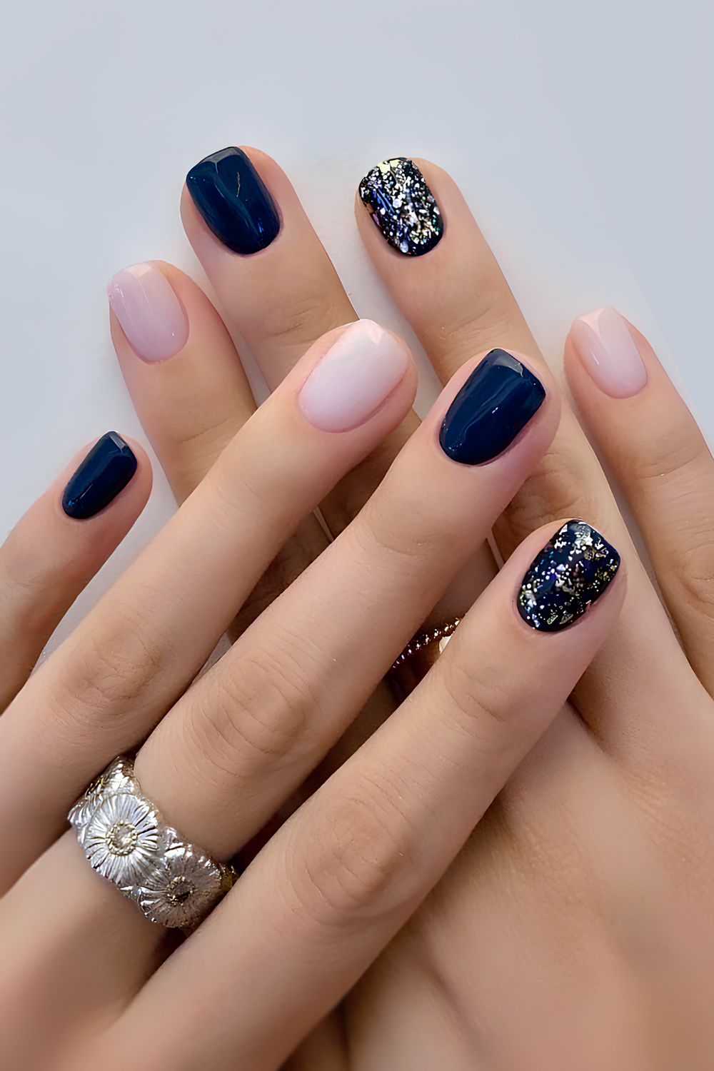 Navy blue and pink mani with glitter accent