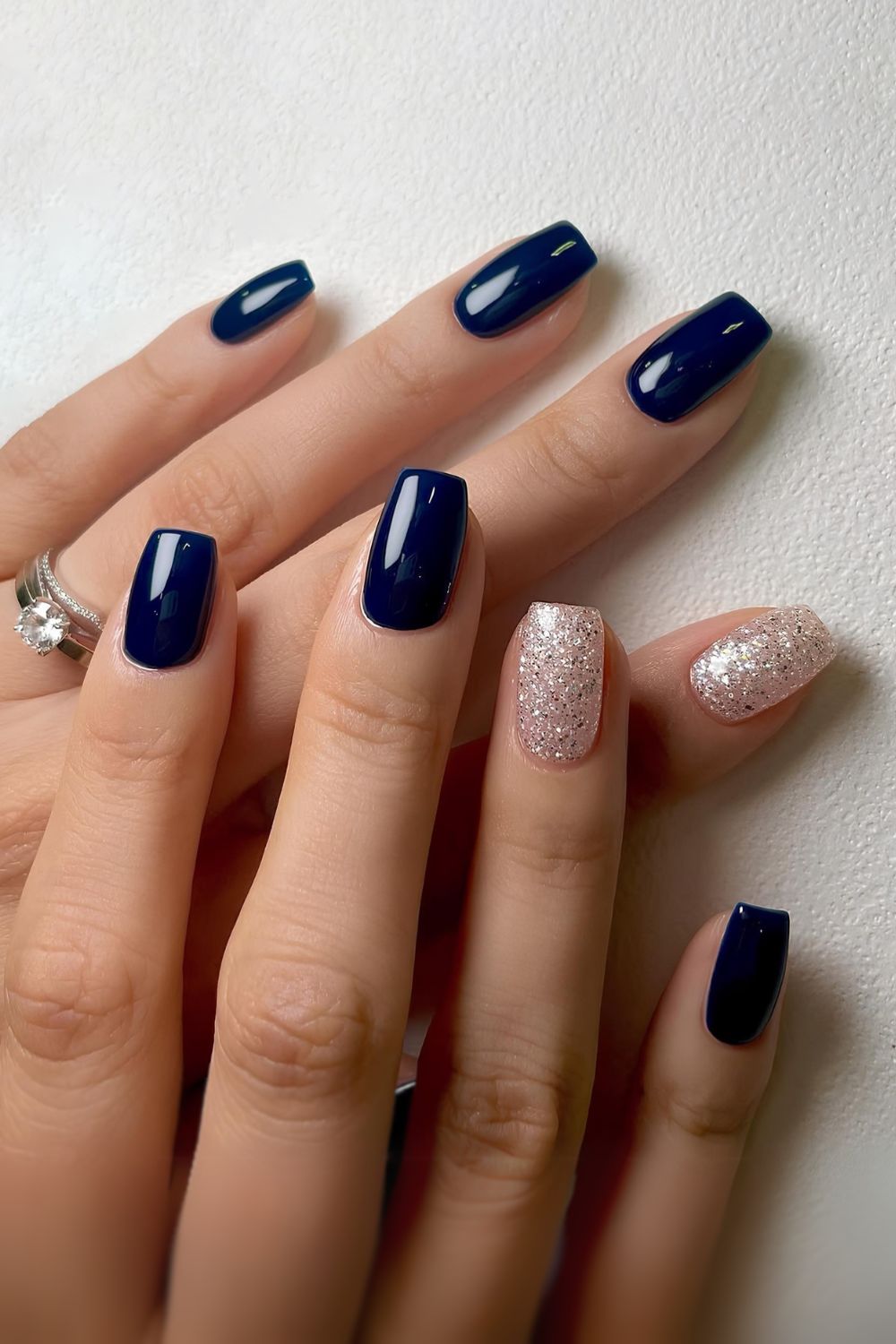 Navy blue mani with silver glitter accents