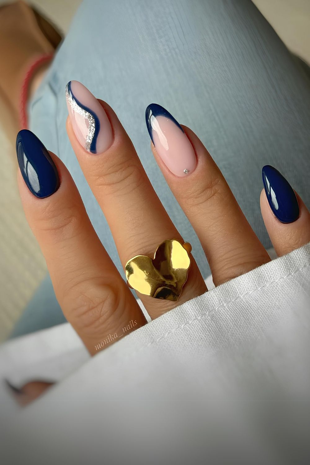 Navy blue mani with swirl and glitter details