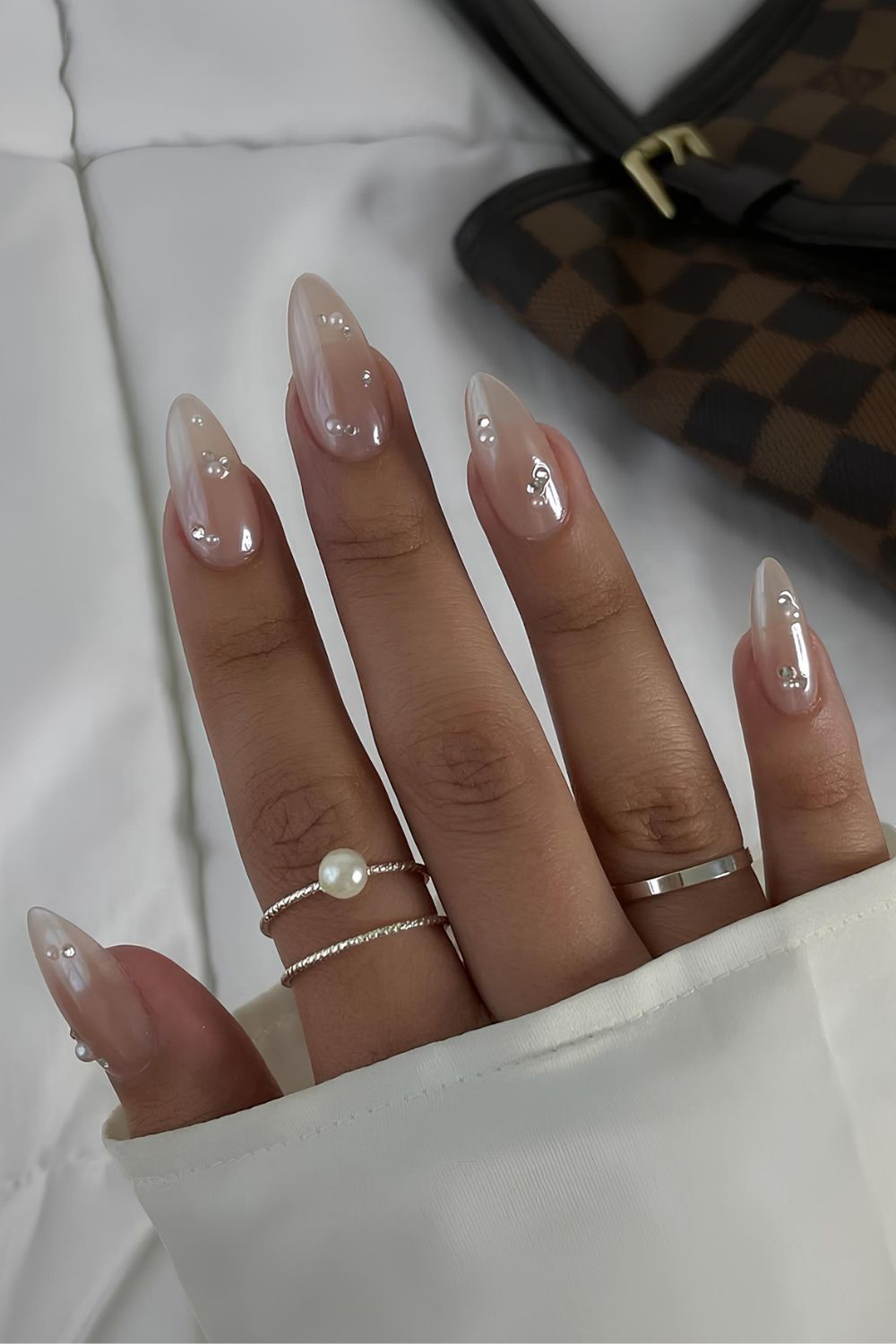 Neutral chrome nails with pearl accents