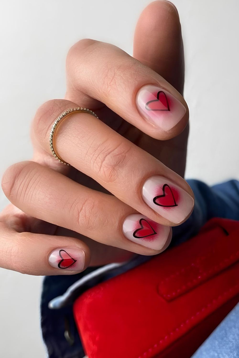 Neutral nails with Red aura effect and black heart accents