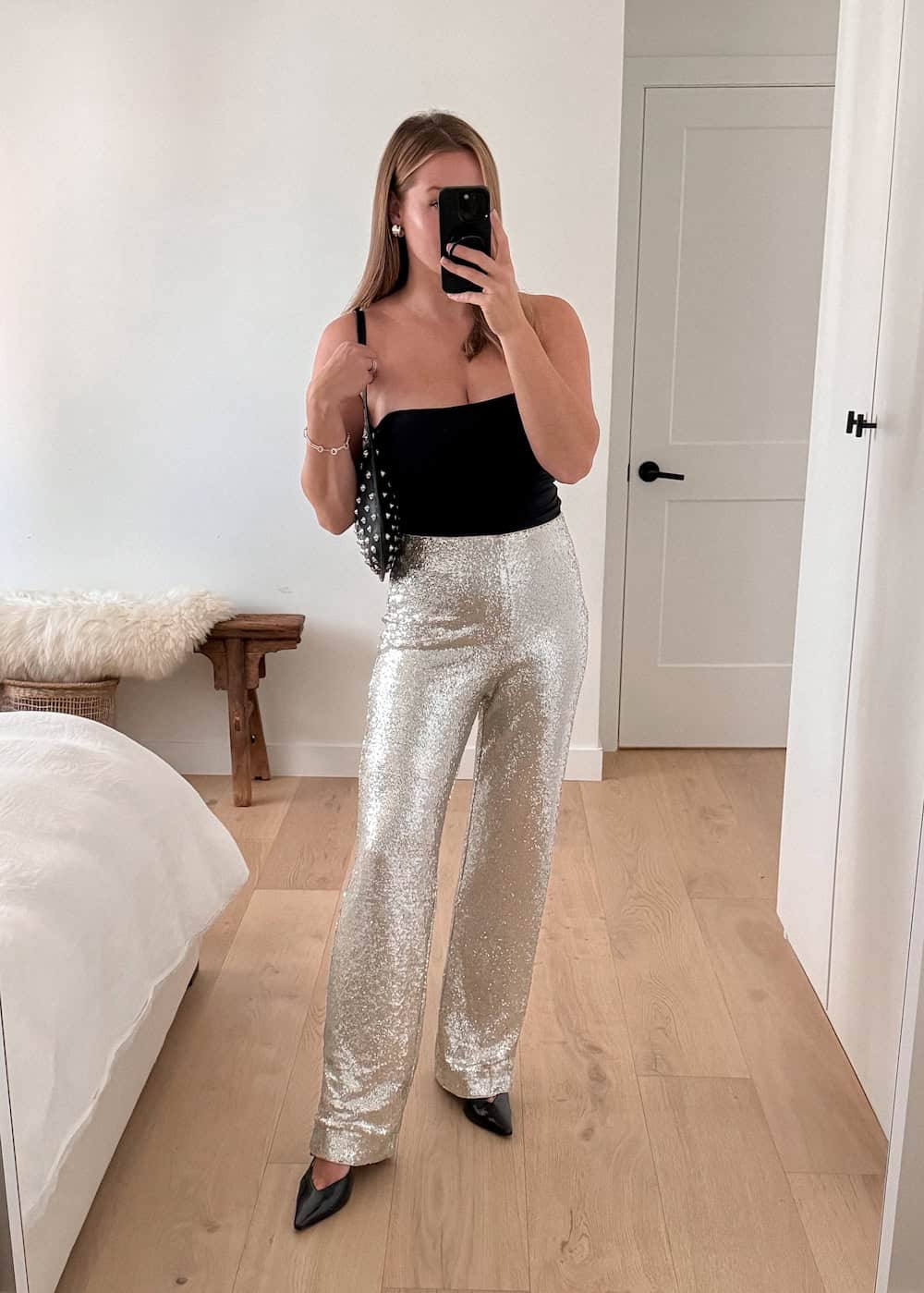 Christal wearing sequined pants with a black tube top and pumps.