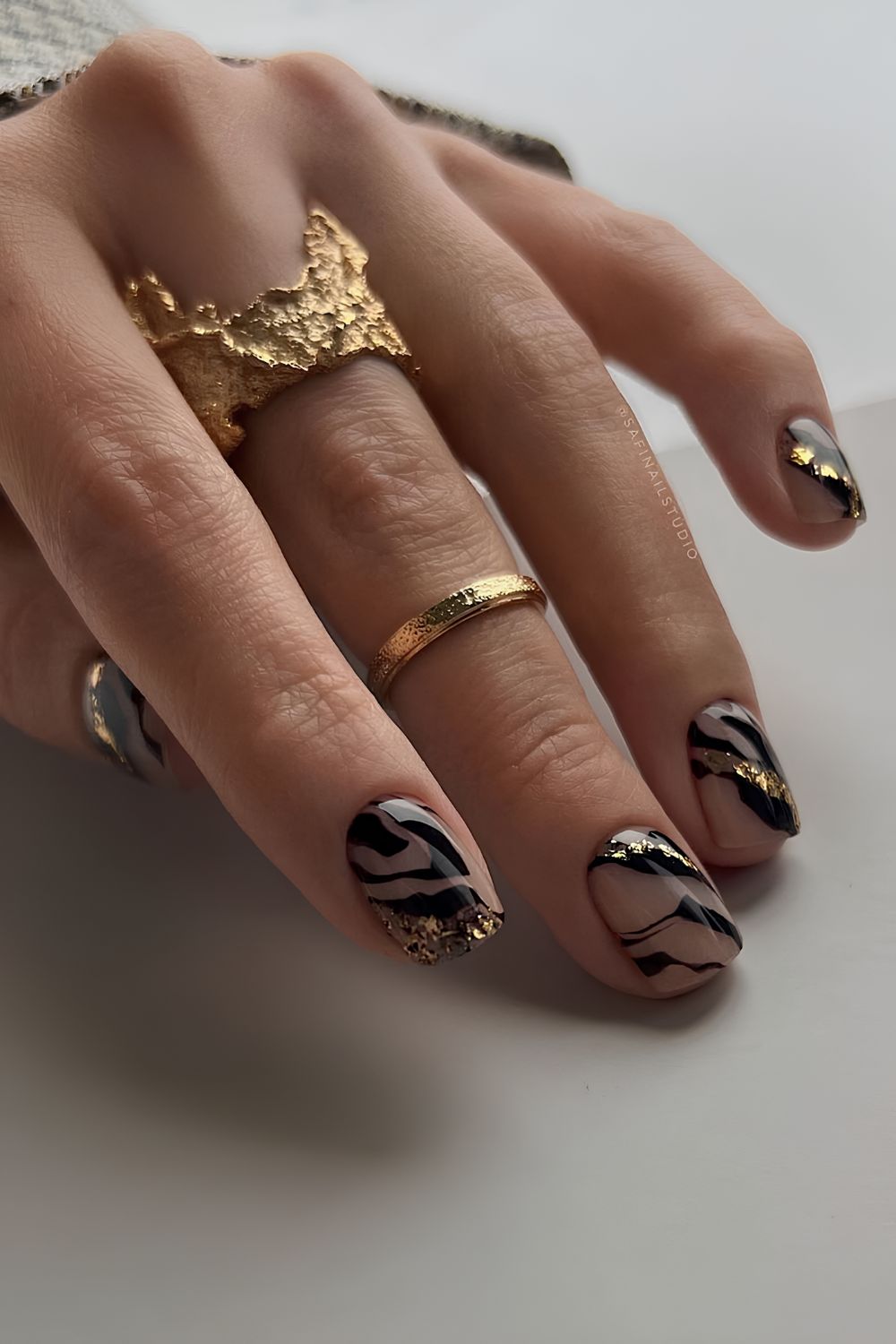 Nude mani with black and gold zebra print