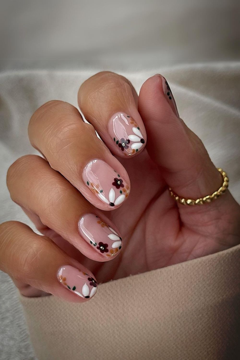 Nude nails with autumn-colored florals