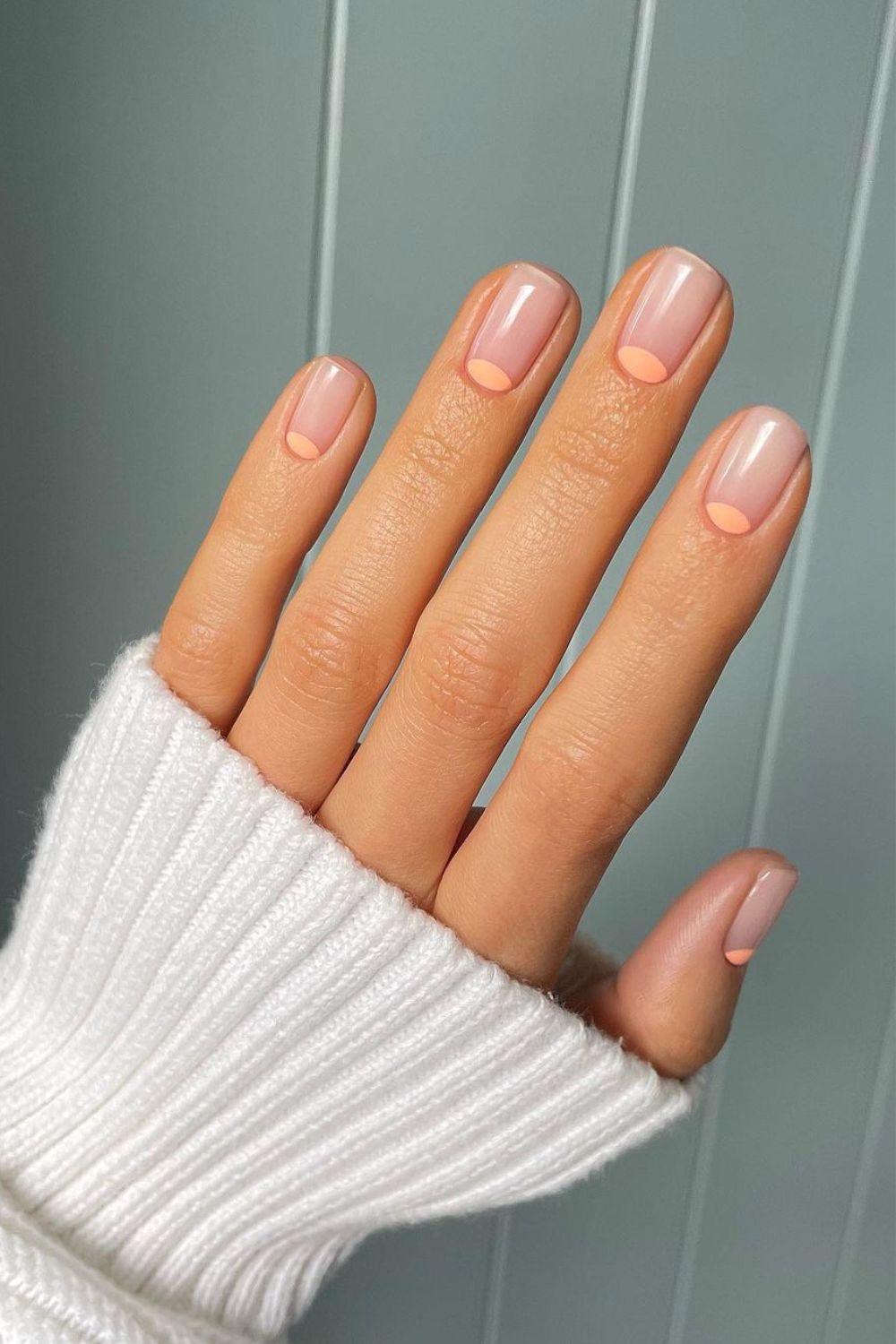 Nude nails with peach half-moon accents