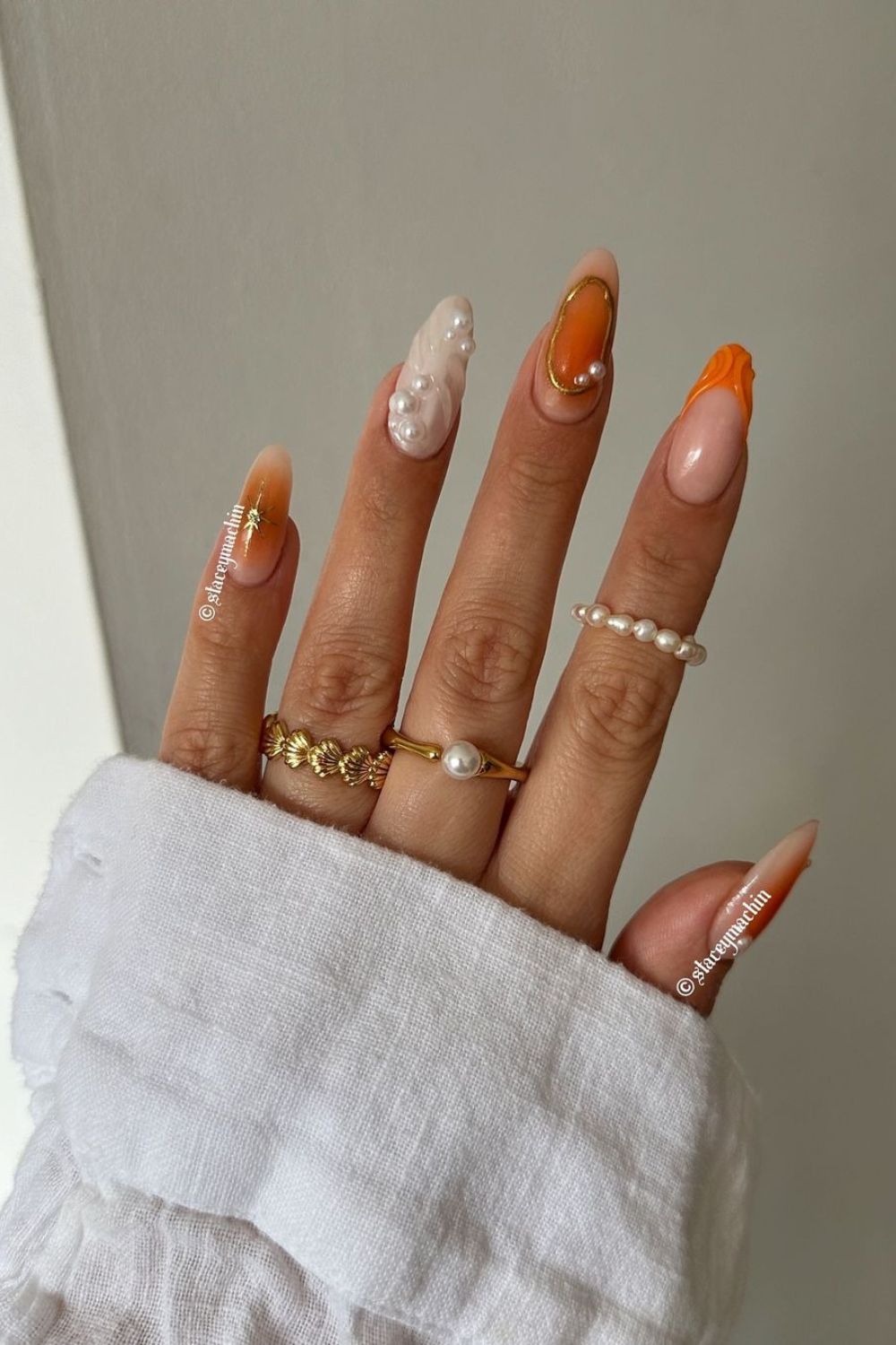 Orange and white mix and match nails with pearls