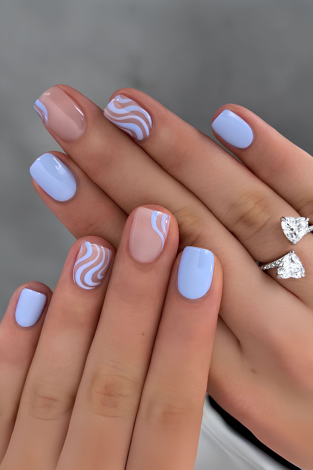 Pastel blue nails with swirly accents