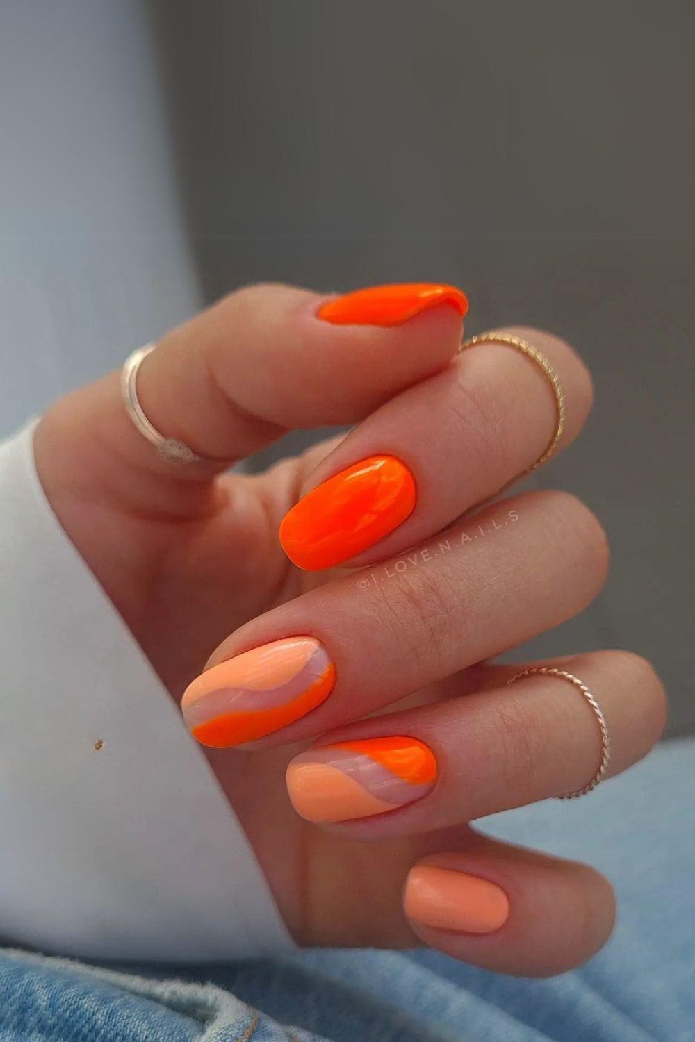 Peach and orange nails with negative space design