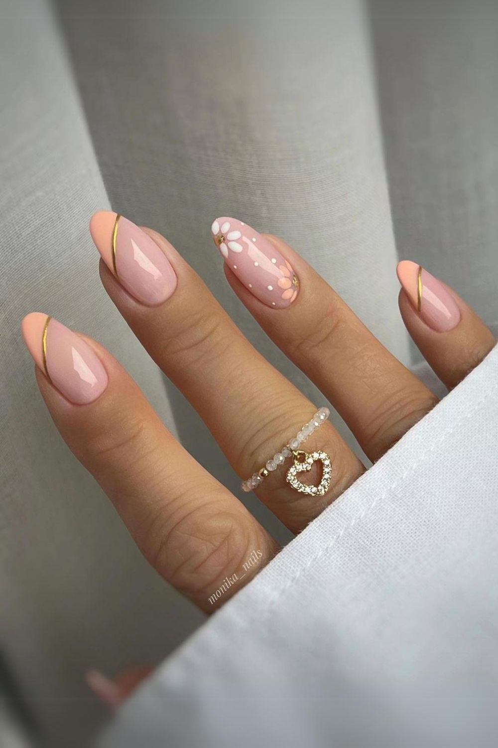 Peach floral nails with gold accents