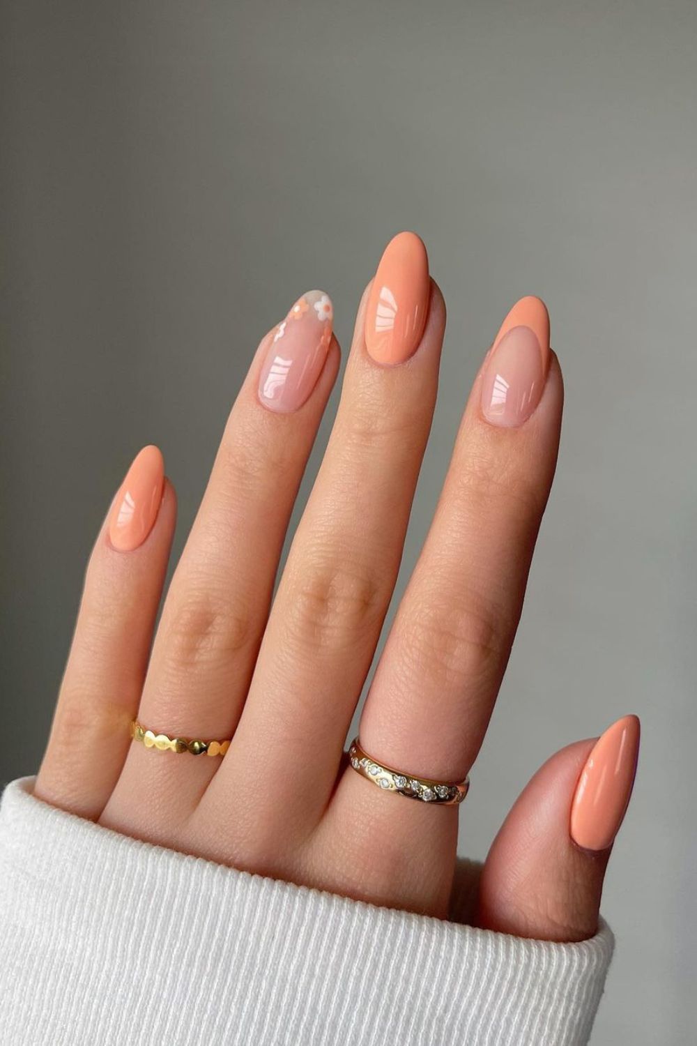 Peach nails with floral and french tip accents