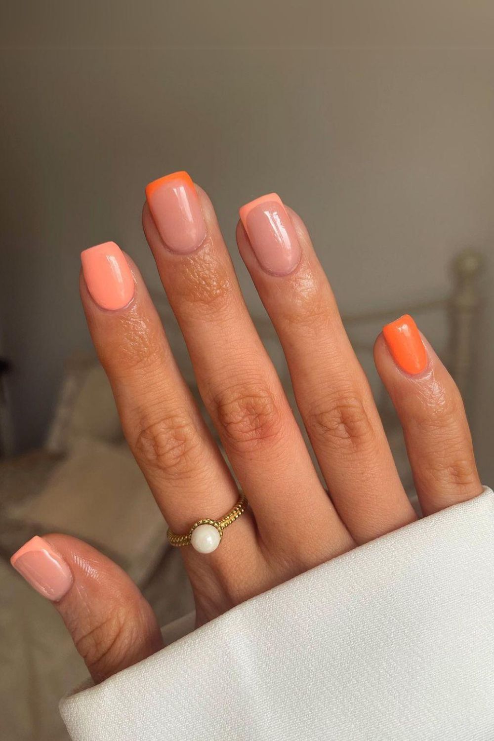 Peachy pink and orange nails with accent tips