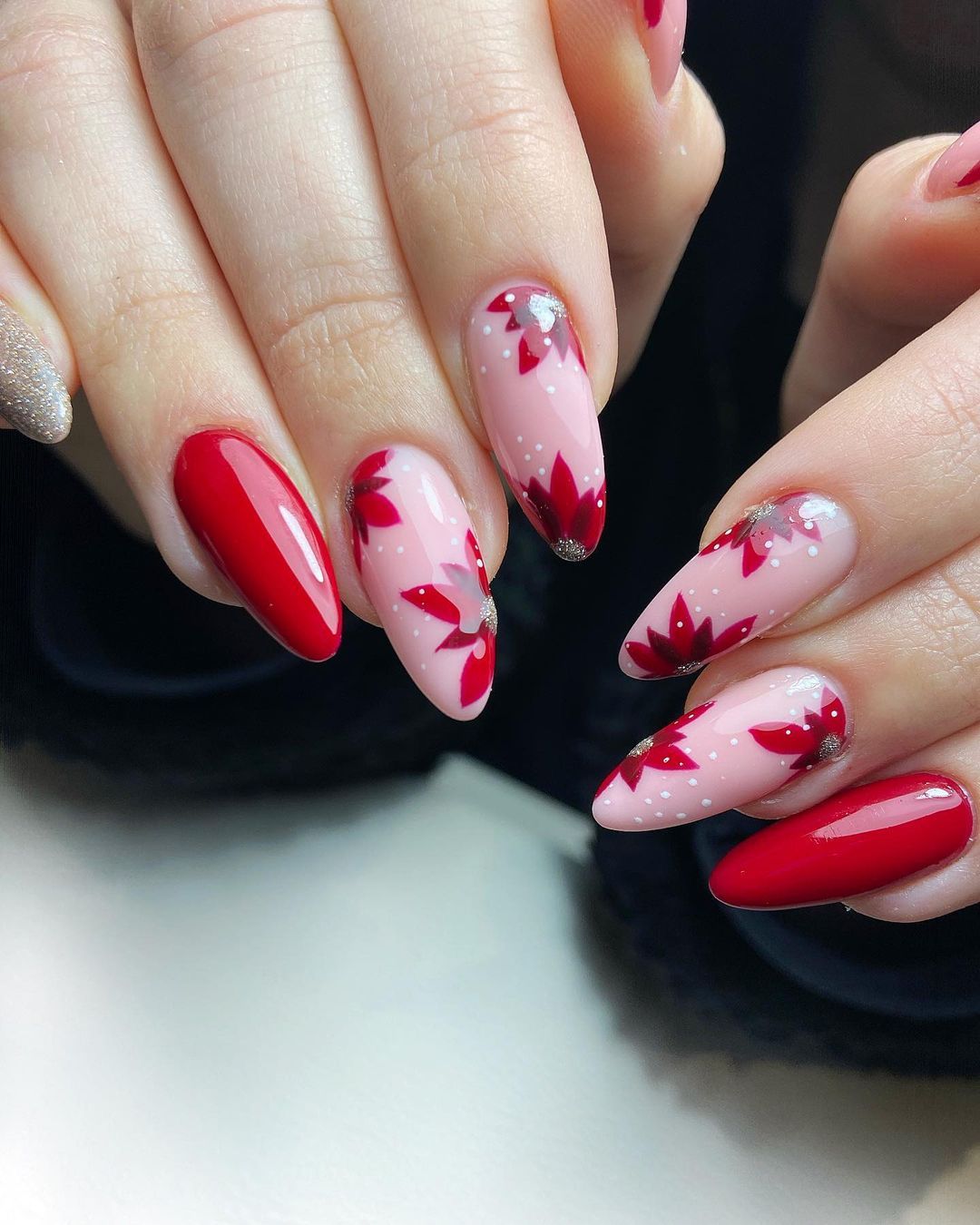 Pink and red nails with poinsettia flower designs