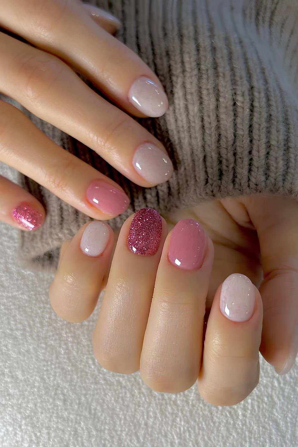 Pink and white skittle nails with glitter accents