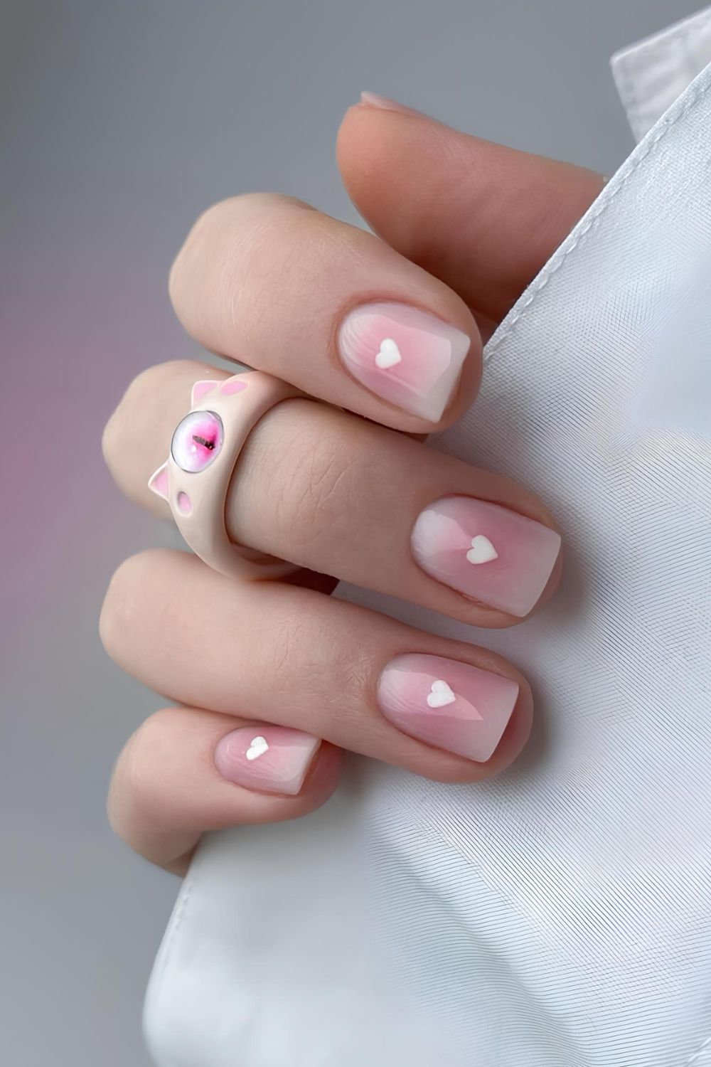 Pink aura nails with white heart accents