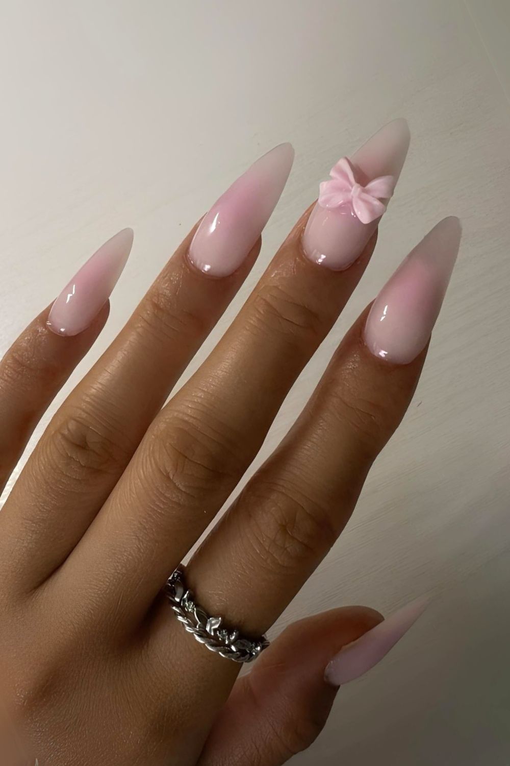 Pink blush-effect nails with bows