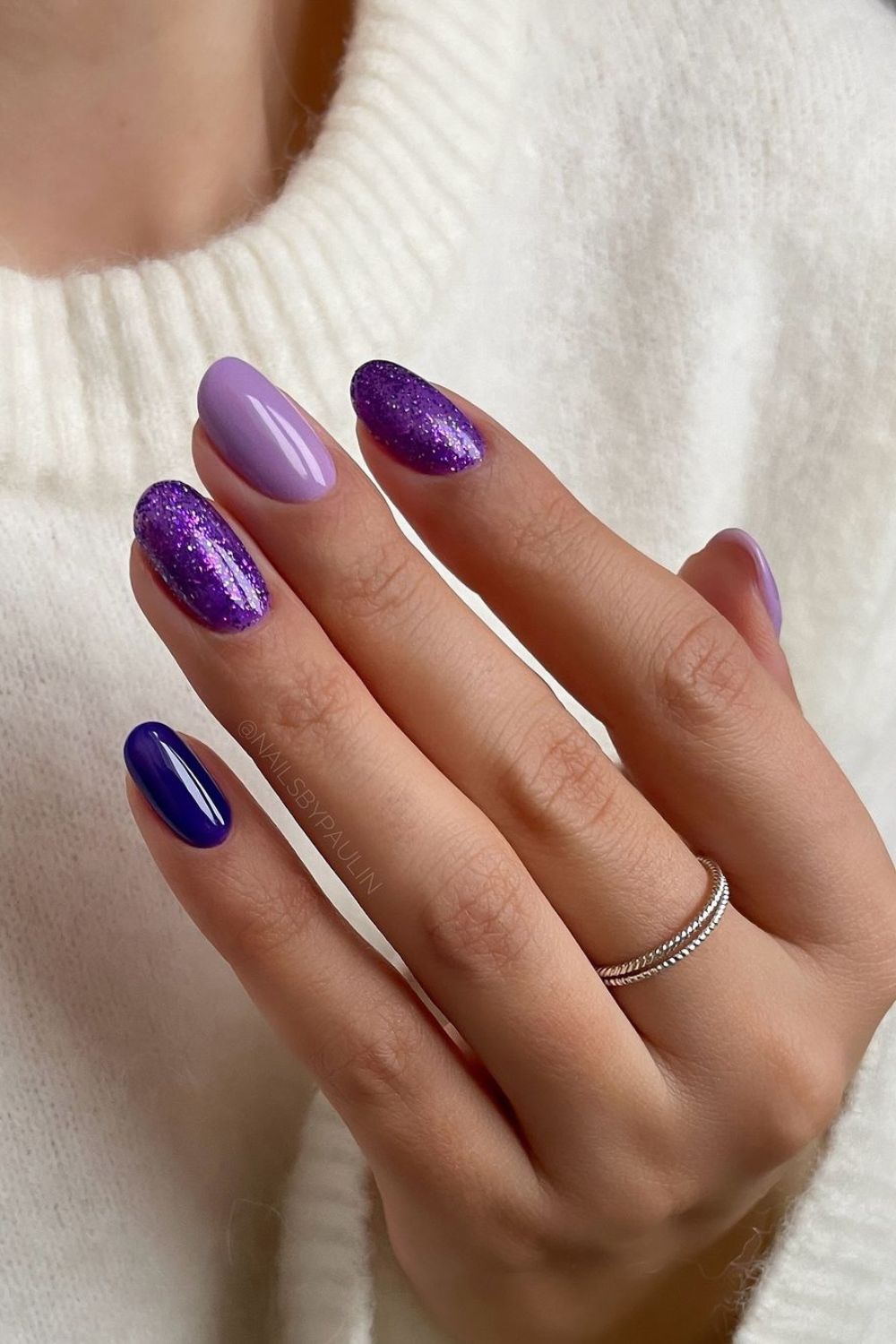 Purple skittle nails with glitter accent