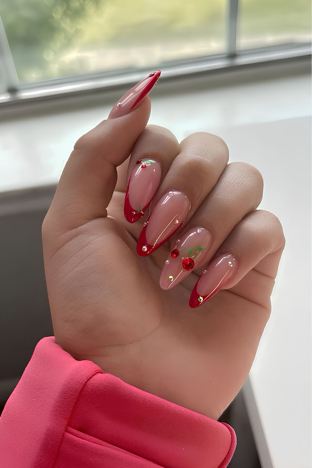 Red French nails with cherry gem accents