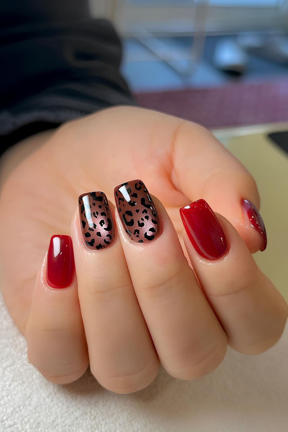 Red and black nails with animal print accent with glass effect